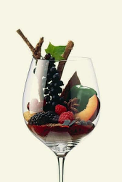 Glas wijn geuld met verse rode vruchten en kruiden
